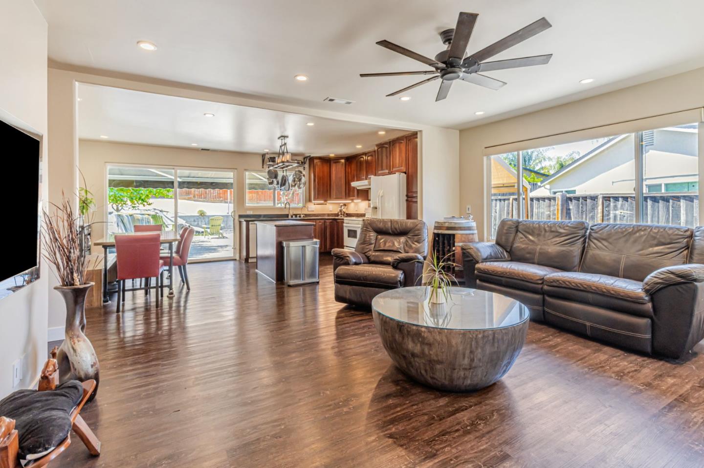 a living room with furniture a large window and a chandelier