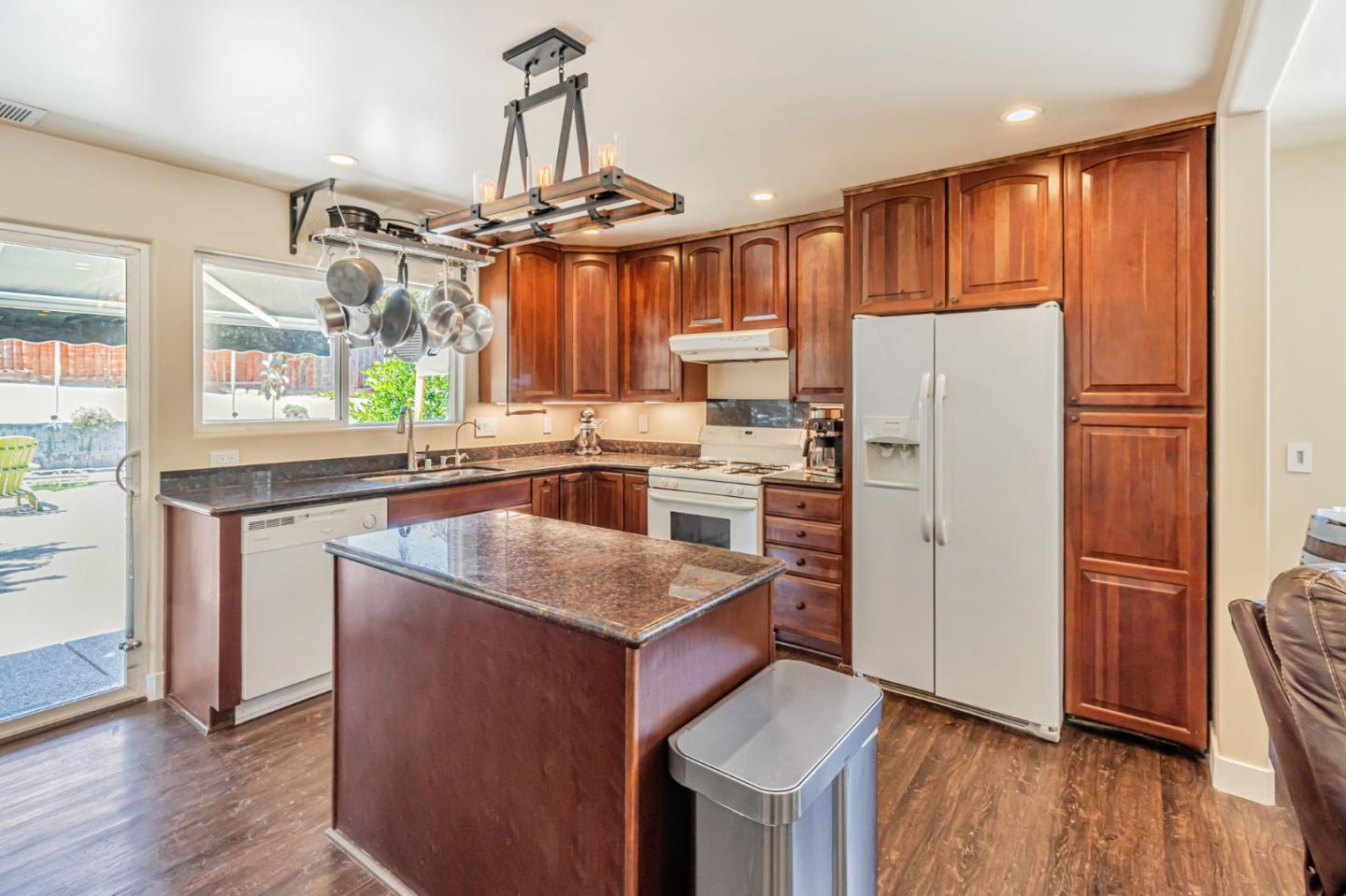 321 Vineyard Drive San Jose, CA 95119 - Photo 5 of 29 a kitchen with refrigerator cabinets and wooden floor