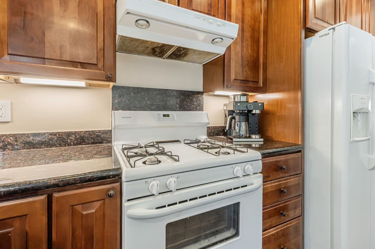 321 Vineyard Drive San Jose, CA 95119 - Photo 7 of 29 a white stove top oven sitting inside of a kitchen