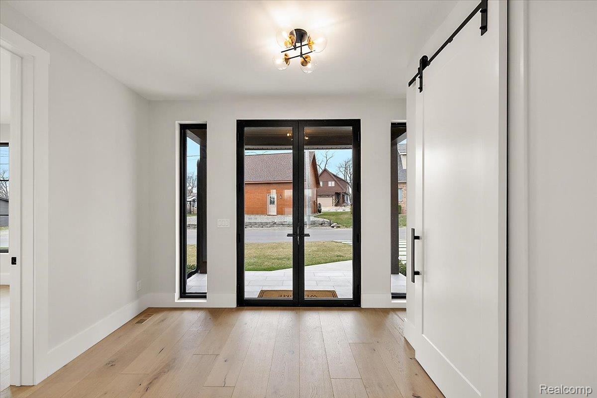 13459 Haddon Street Fenton, MI 48430 - Photo 27 of 84 Doorway to outside with a barn door and hardwood / wood-style flooring