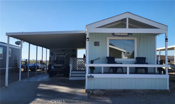 a view of a living room kitchen with furniture and wooden floor
