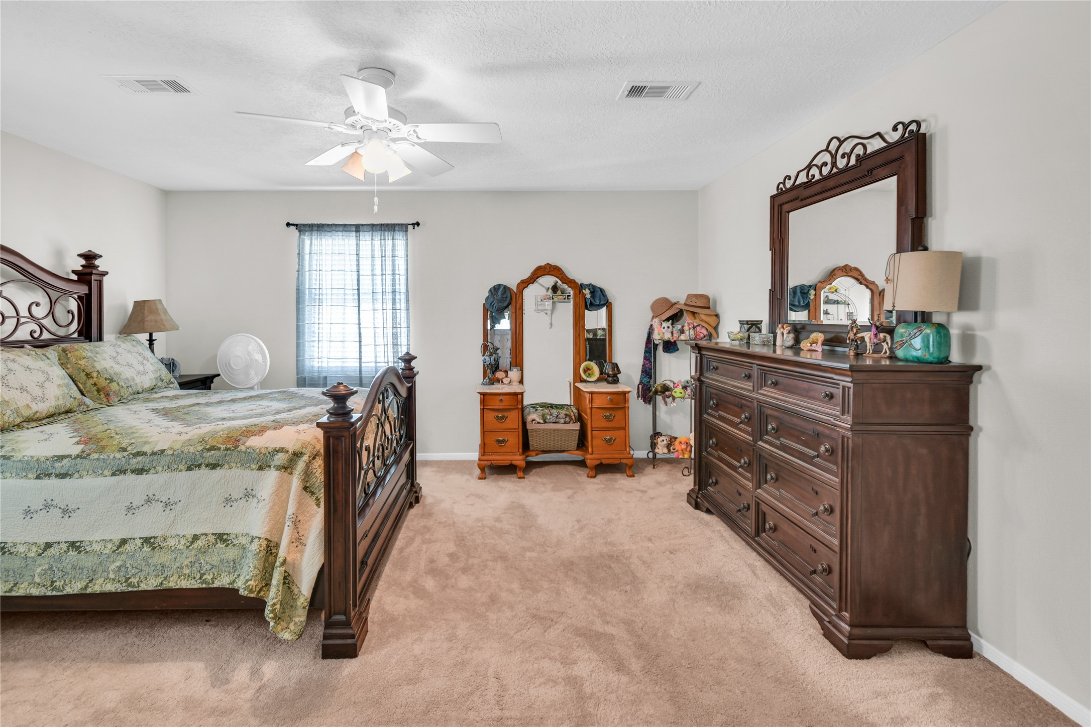115 Driftwood Road Freeport, TX 77541 - Photo 19 of 21 a bedroom with a bed and a chandelier