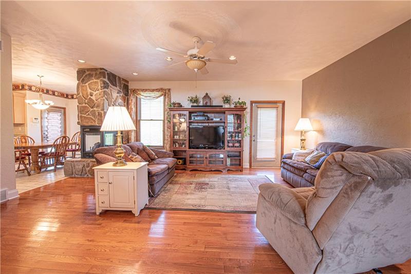 240 Durst Road Irwin, PA 15642 - Photo 7 of 24 Great Room with gleaming HW floors, 9 foot ceilings and Stone Peninsula Gas FP is stunning.