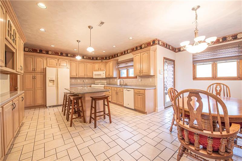 240 Durst Road Irwin, PA 15642 - Photo 8 of 24 Spacious and dreamy eat in kitchen (~19x22). Plenty of cabinets and counterspace. Ceramic floors. Kitchen island w/prep sink.