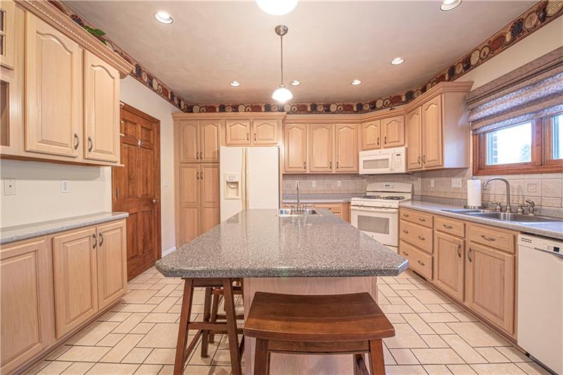 240 Durst Road Irwin, PA 15642 - Photo 9 of 24 Manor House Eat-in-Kitchen. Ceramic Floors. Ceramic Backsplash. Pantry, Ref, New DW (6 mo), Gas Stove w/warmer (2 mo), 2 disposals, blinds, recessed lights, etc.