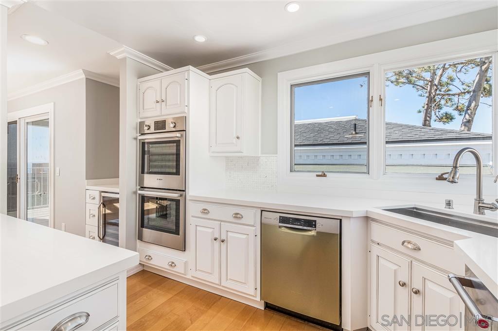 862 Prospect Street, Unit 1 La Jolla, CA 92037 - Photo 12 of 25 a kitchen with stainless steel appliances a sink stove and refrigerator