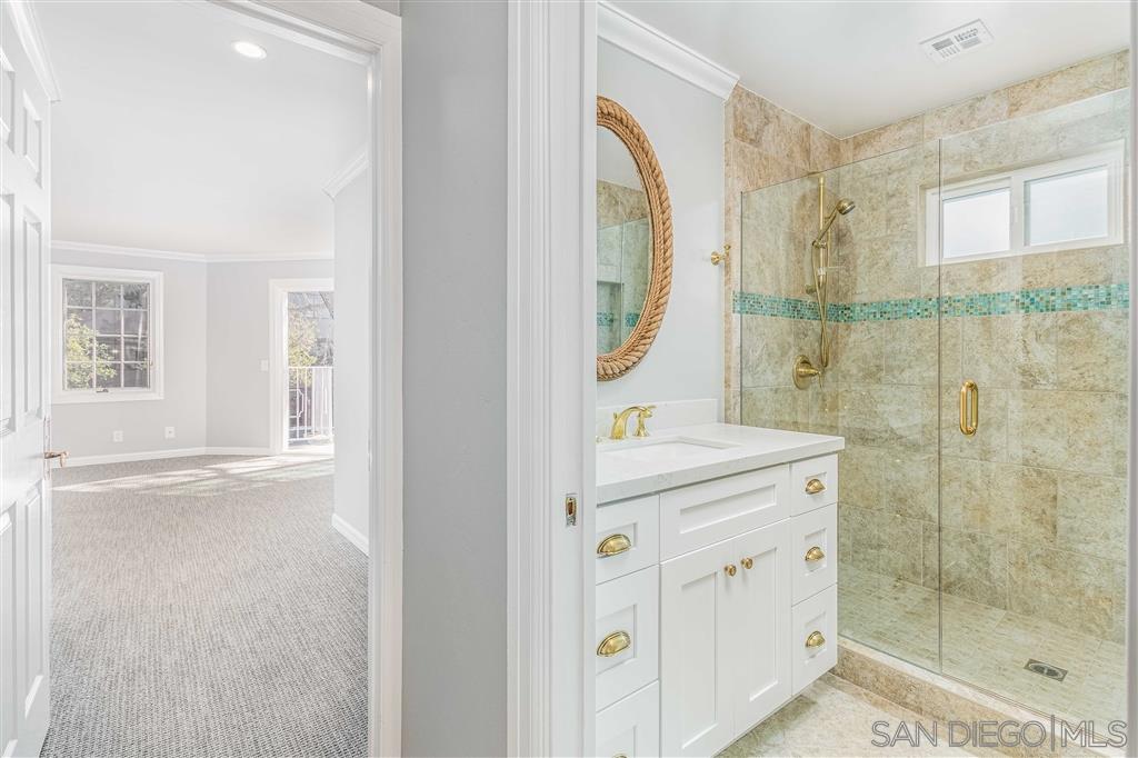 862 Prospect Street, Unit 1 La Jolla, CA 92037 - Photo 17 of 25 a bathroom with a shower sink and mirror