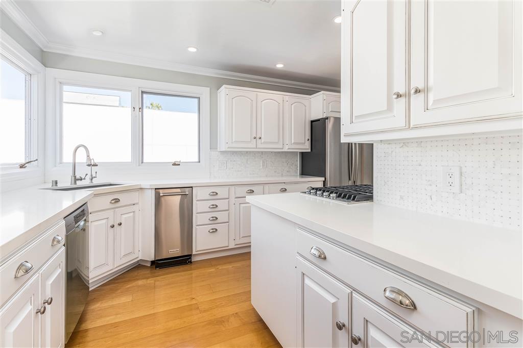 862 Prospect Street, Unit 1 La Jolla, CA 92037 - Photo 7 of 25 a kitchen with cabinets appliances a sink and a window