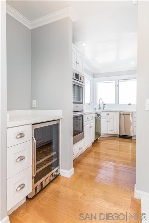 862 Prospect Street, Unit 1 La Jolla, CA 92037 - Photo 8 of 25 a view of a kitchen with a stove cabinets and a kitchen counter space