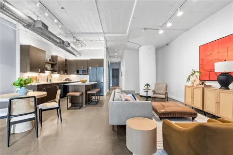 a dining room with furniture and a chandelier