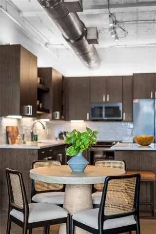 a kitchen with a table and chairs in it