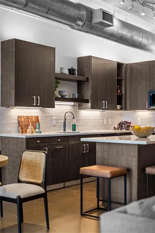 a kitchen with a sink cabinets and wooden floor