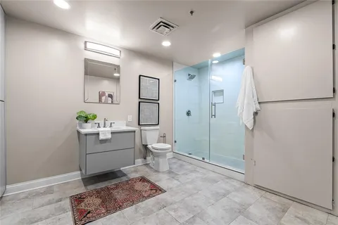 a bathroom with a sink a toilet and shower