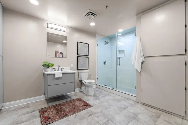 a bathroom with a sink a toilet and shower