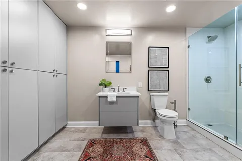 a bathroom with a toilet sink and shower