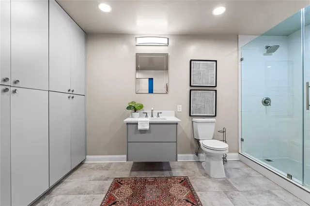 a bathroom with a toilet sink and shower