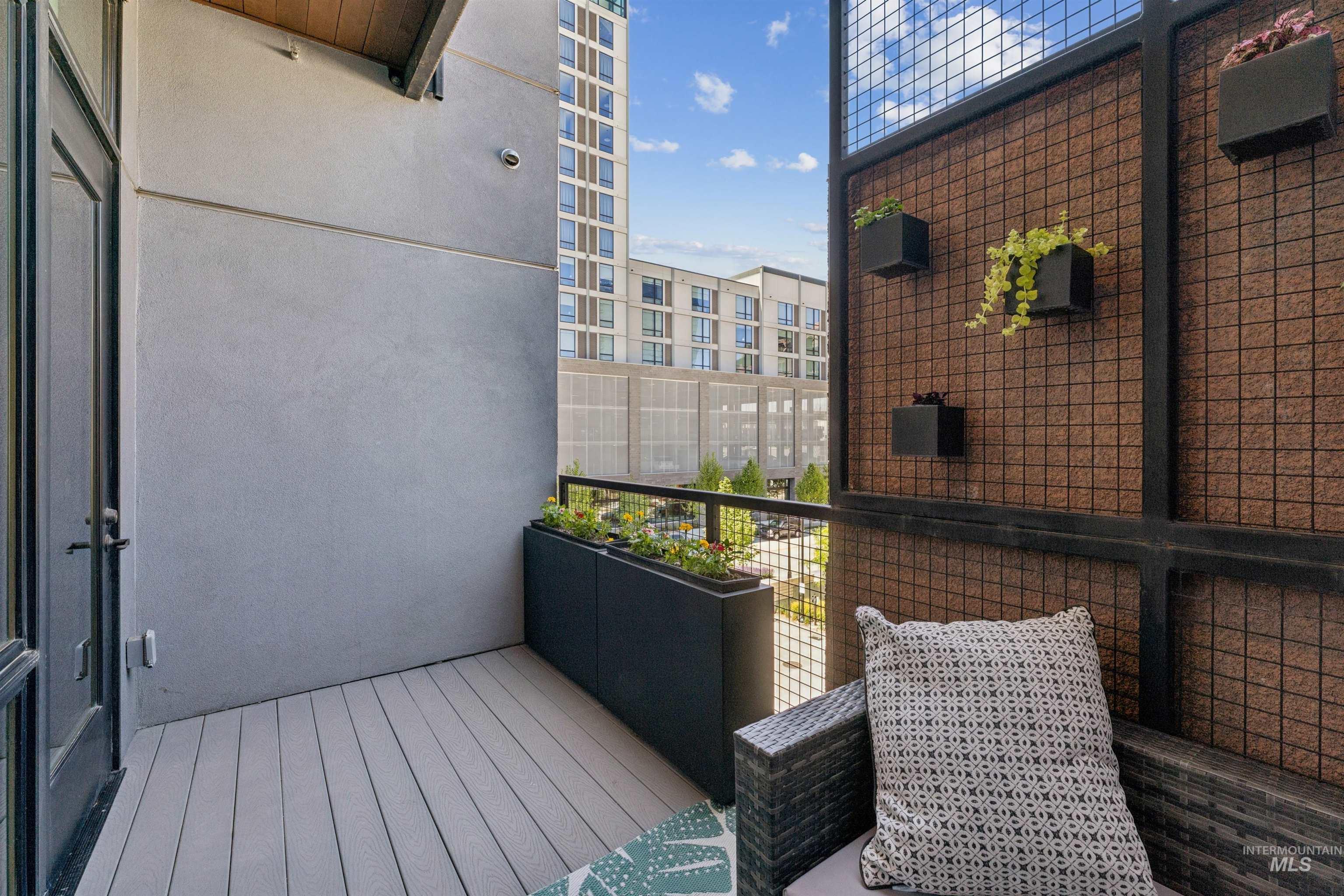 119 South 10th Street, Unit 307 Boise, ID 83702 - Photo 27 of 47 Private balcony featuring composite decking, a metal railing, and an integrated planter box
