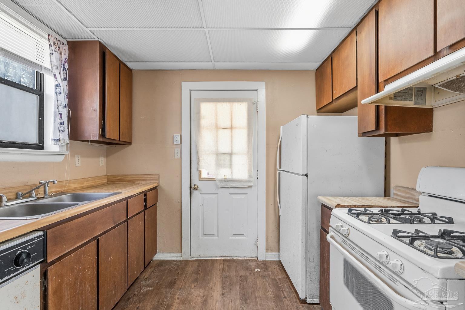 1920 North Spring Street Pensacola, FL 32501 - Photo 16 of 43 a kitchen with a stove and a refrigerator