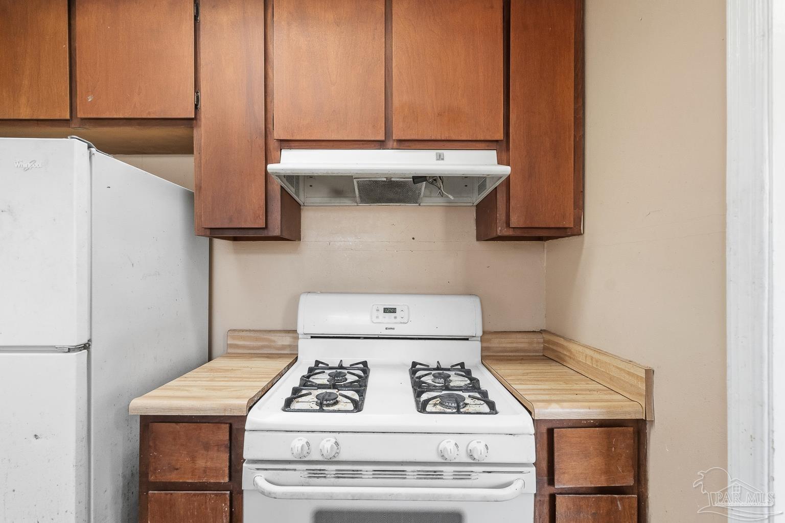 1920 North Spring Street Pensacola, FL 32501 - Photo 20 of 43 a white stove top oven sitting inside of a kitchen