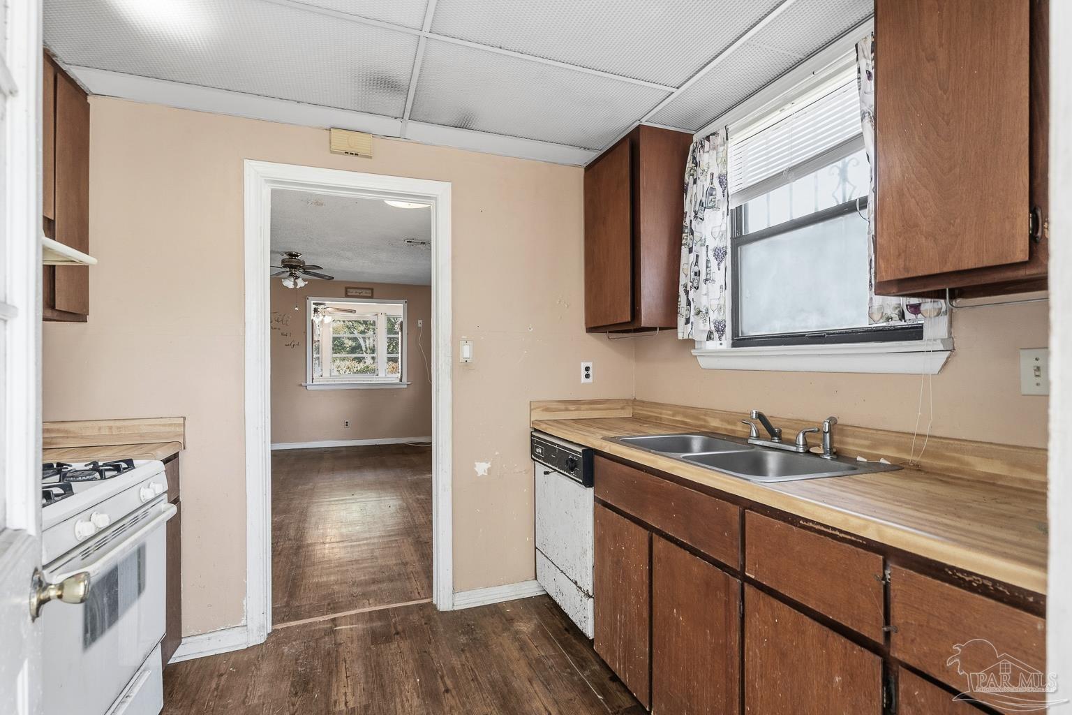 1920 North Spring Street Pensacola, FL 32501 - Photo 22 of 43 a kitchen with stainless steel appliances granite countertop a sink stove and refrigerator