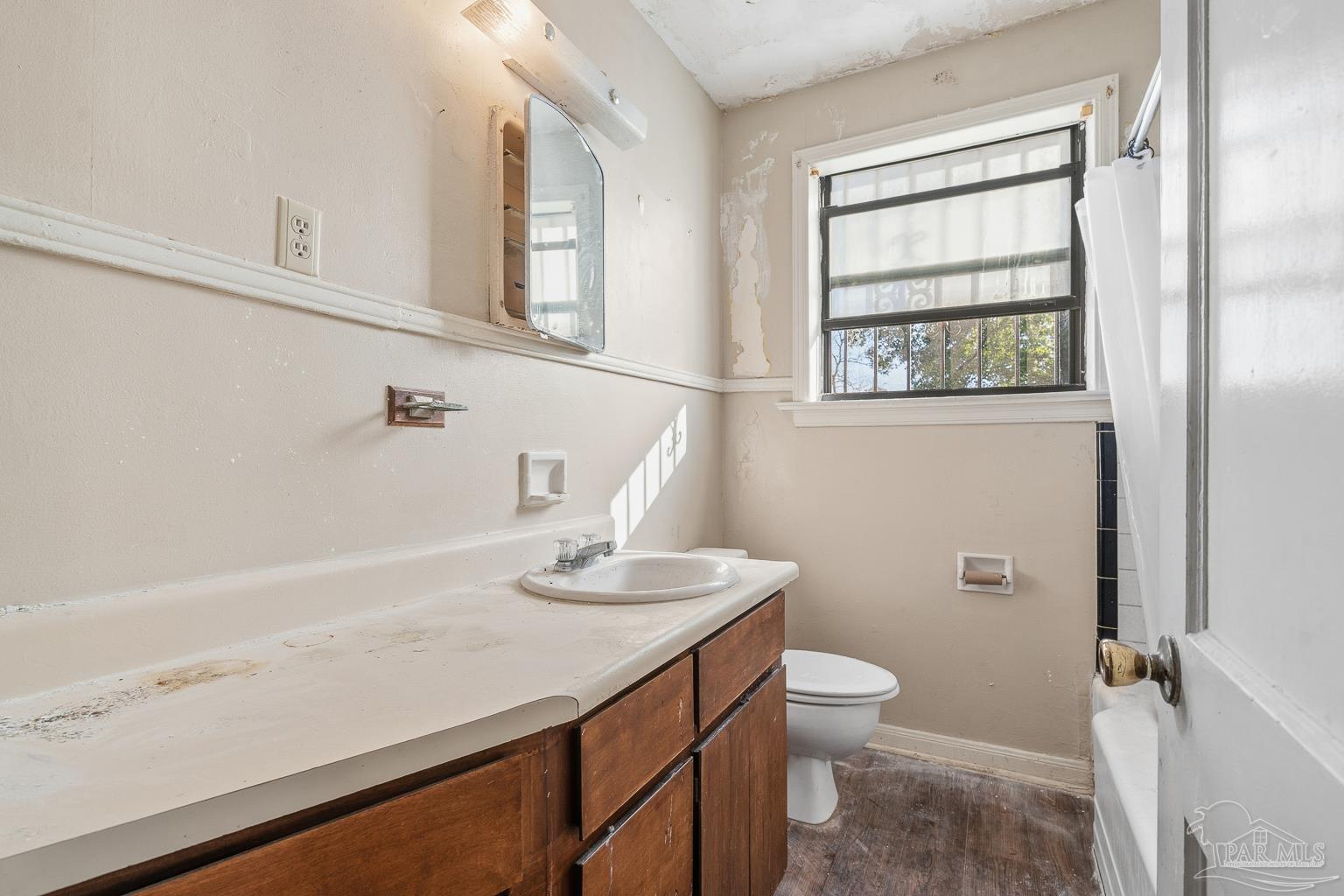 1920 North Spring Street Pensacola, FL 32501 - Photo 30 of 43 a bathroom with a sink a toilet and a window