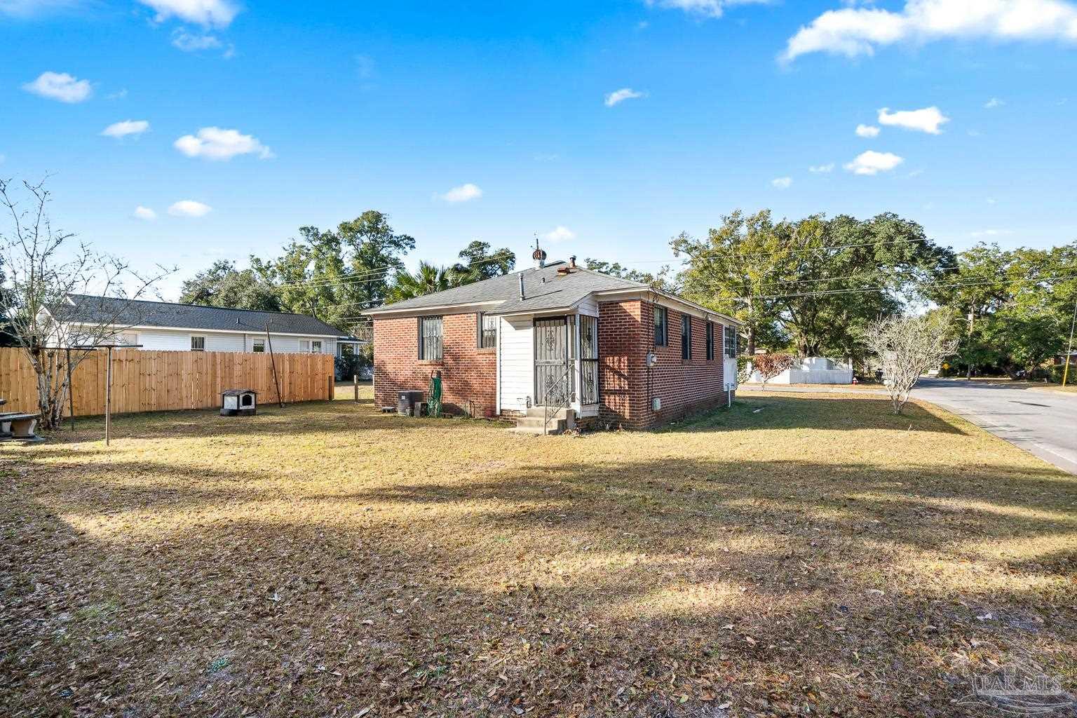 1920 North Spring Street Pensacola, FL 32501 - Photo 41 of 43 a view of a house with a backyard and a tree