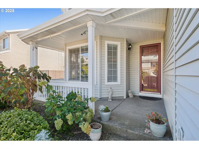 a view of a house with potted plants
