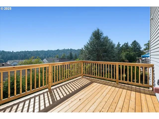 a view of balcony with wooden floor and fence