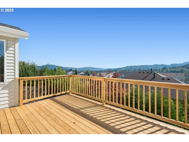 a view of balcony with wooden floor and fence