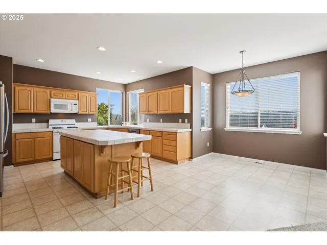 a kitchen with a sink window and cabinets