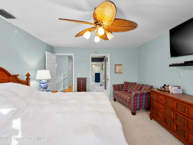 a bedroom with bed and flat screen tv