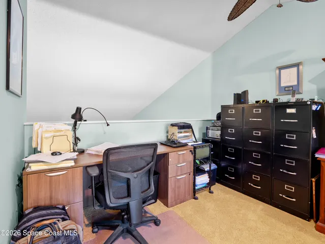 a bed room with a bed and a chair