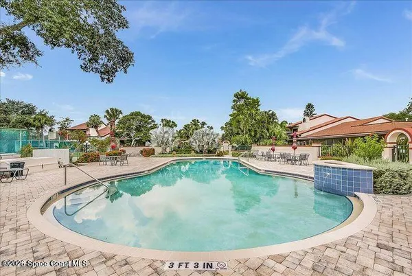 a view of a swimming pool with an outdoor seating