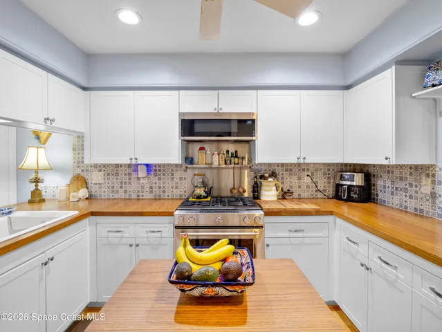 a kitchen with stainless steel appliances granite countertop a sink and cabinets