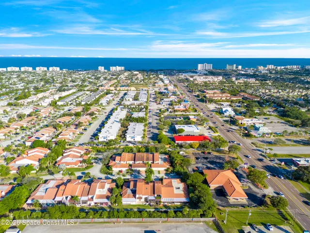 a view of a patio with table and chairs and potted plants