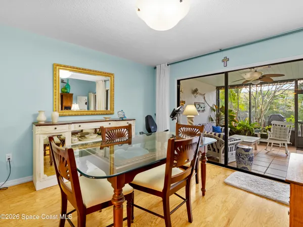 a dining room with furniture and wooden floor
