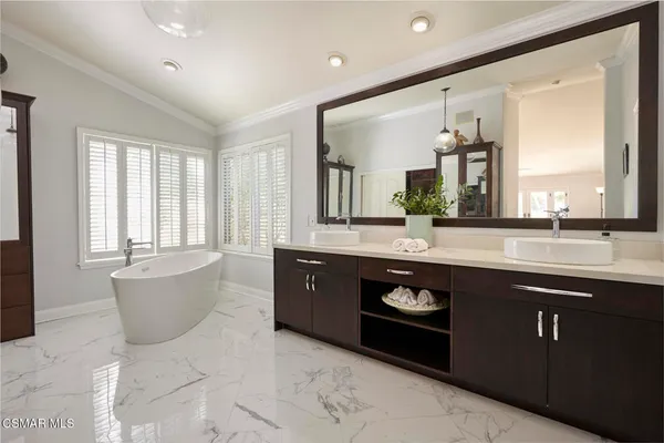 a spacious bedroom with a bed and a window