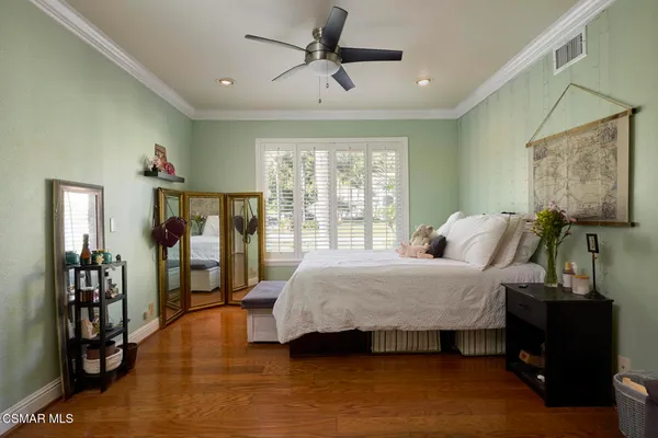 a bedroom with a bed and a couch