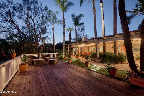 an outdoor space with patio furniture and potted plants