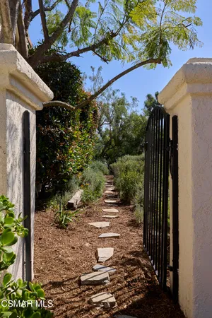 a view of a house with a yard and garden