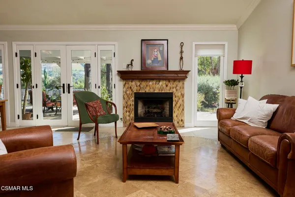 a kitchen with stainless steel appliances granite countertop table chairs sink and cabinets