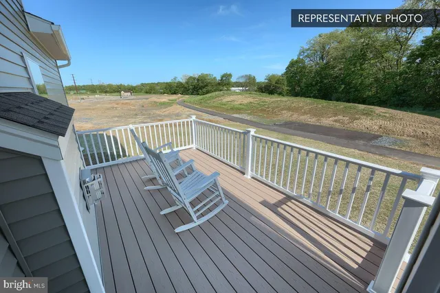 a view of balcony with wooden floor and fence