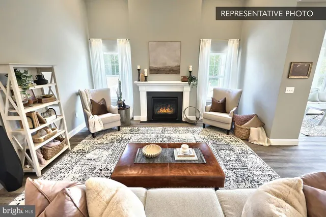 a living room with furniture a fireplace and a table