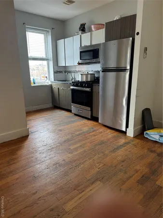 a kitchen with stainless steel appliances a refrigerator stove microwave and sink