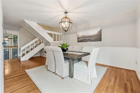 a view of a dining room with furniture wooden floor and front door