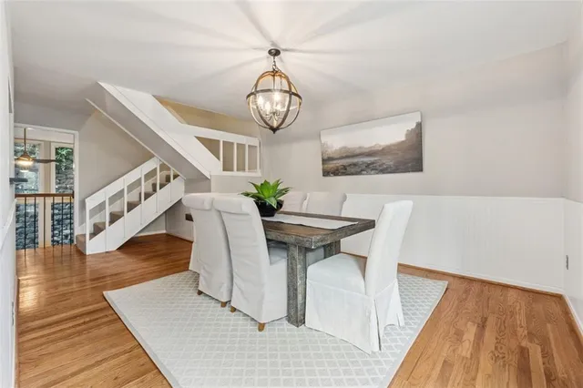 a view of a dining room with furniture wooden floor and front door
