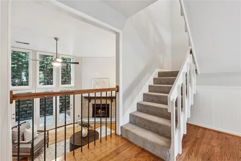 a view of entryway and hall with wooden floor