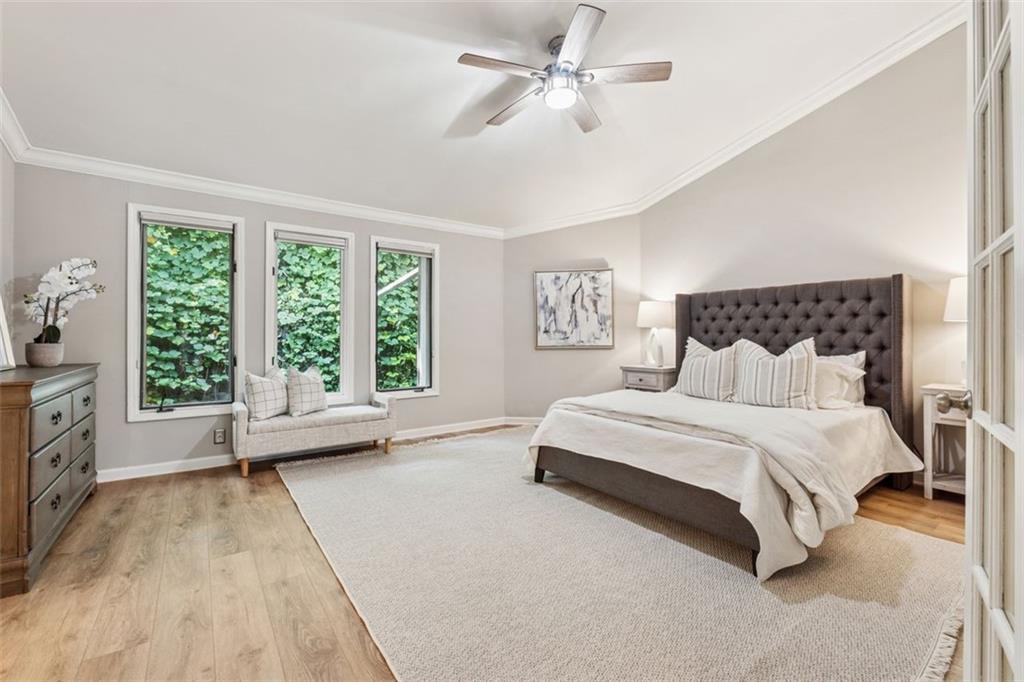 4010 Roswell Road Northeast, Unit A2 Atlanta, GA 30342 - Photo 18 of 32 a spacious bedroom with a bed a couch and large window