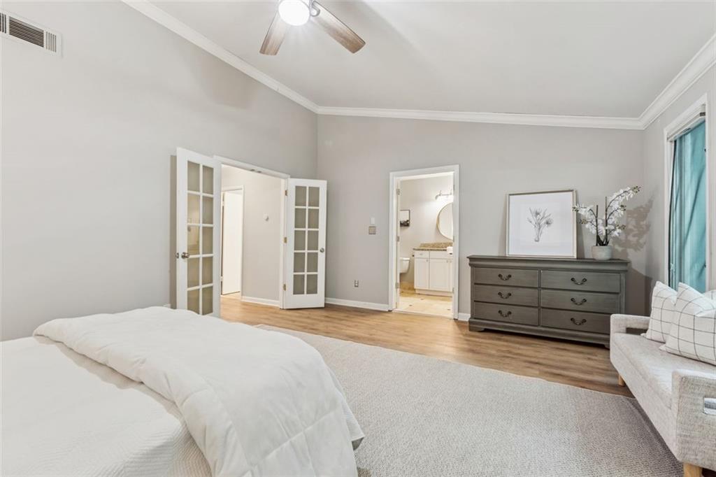 4010 Roswell Road Northeast, Unit A2 Atlanta, GA 30342 - Photo 19 of 32 a bedroom with a bed and a chandelier