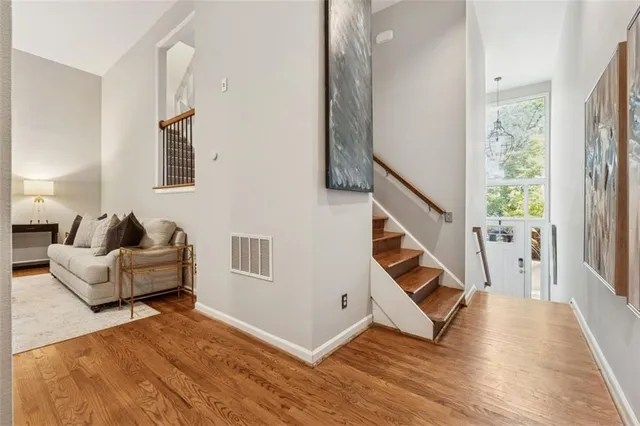 a living room with furniture and stairs